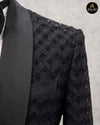 Close view of geometric embroidery and satin shawl lapel on black tuxedo - Abito Men