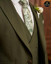 Close view of olive green suit lapel, paisley tie and waistcoat - Abito Men