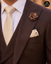 Close view of chocolate brown suit lapel flower pin and pocket square - Abito Men