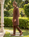 Side view of brown groom sherwani with turban and traditional shoes - Abito Men